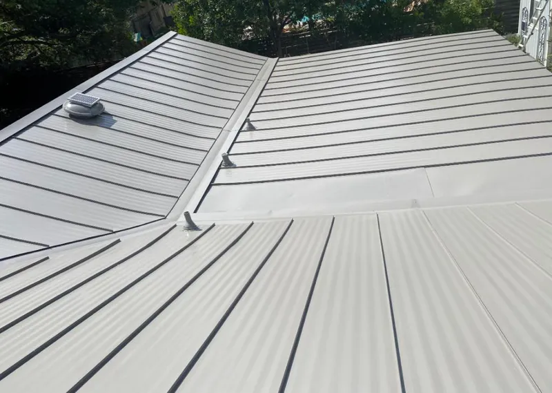 Solar attic fan installed on a metal roof for Roof Ventilation in Hiawatha